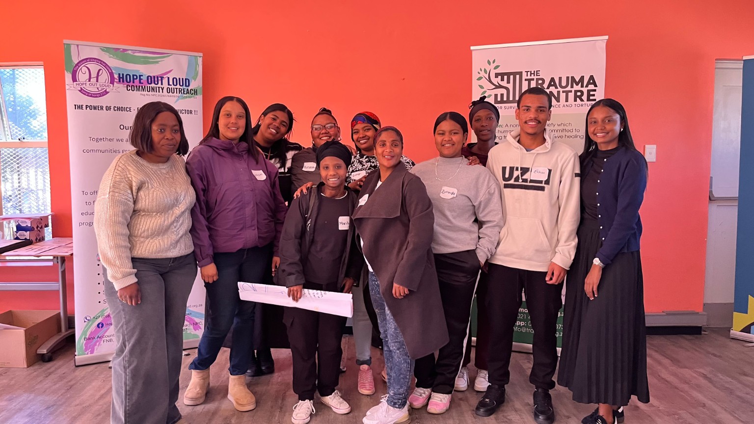 Young people and community participants standing together at a connection-building event
